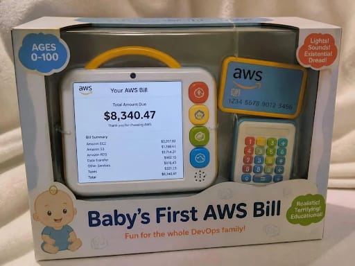 Joke toy box 'Baby's First AWS Bill' showing an $8,340.47 bill, billed as fun for the whole DevOps family