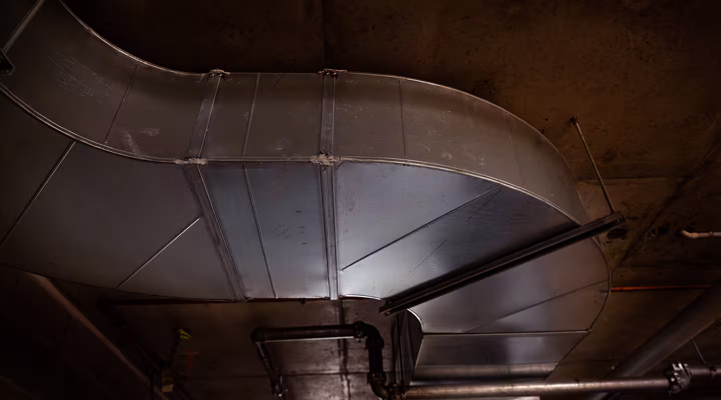 A fabricated sheet metal exhaust duct bend ready for installation