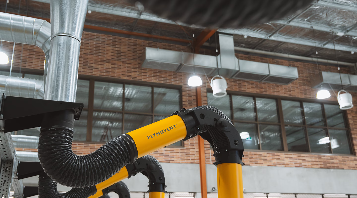 A Plymovent fume extraction arm installed in a commercial workshop