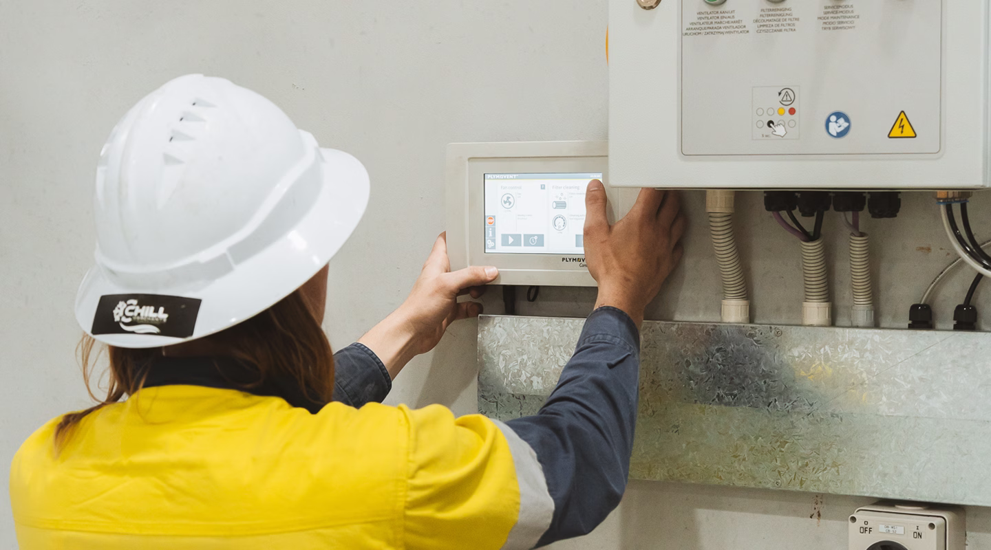 Chill Merchants technician checking a commercial HVAC electrical control panel