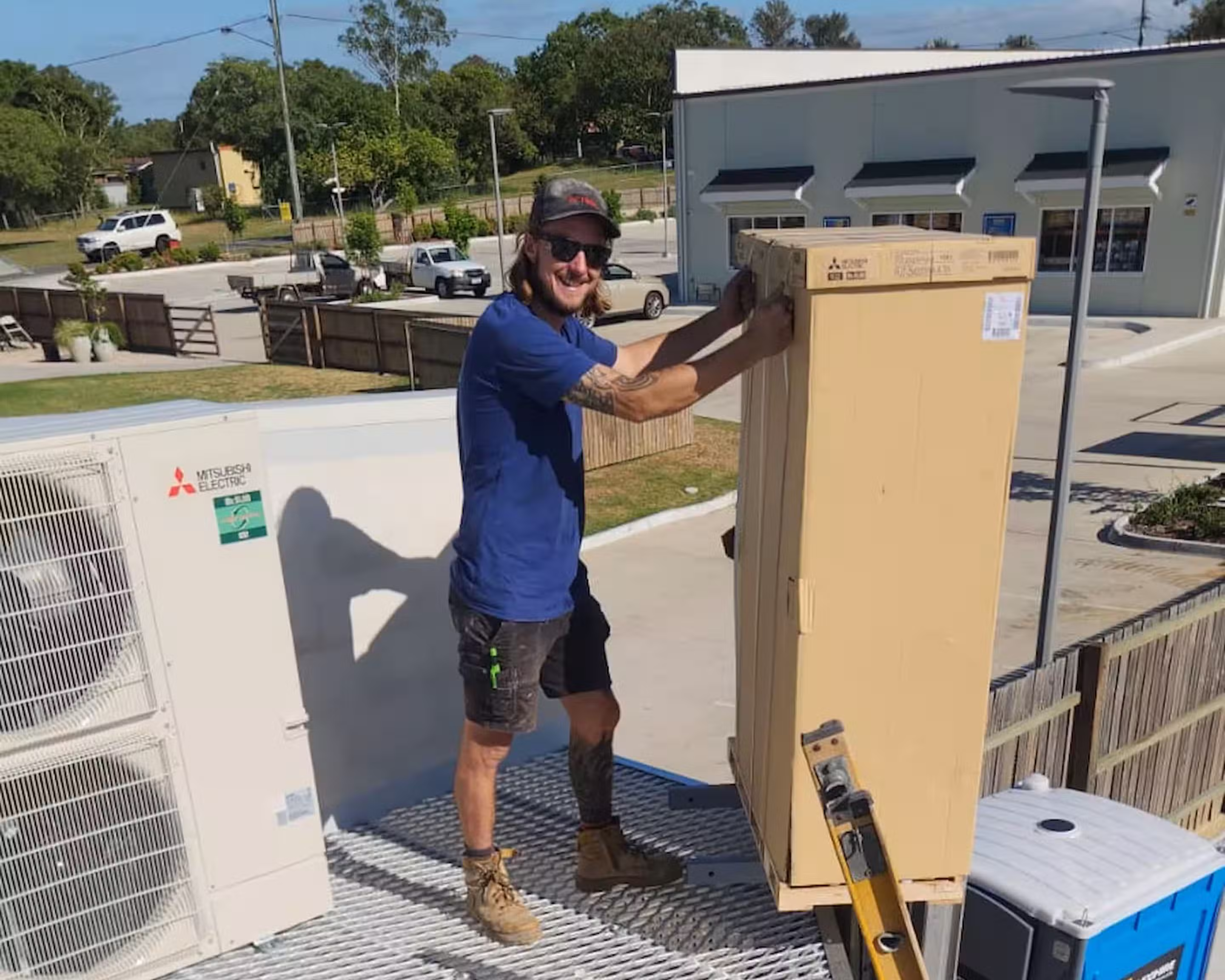 Chill Merchants technician standing beside commercial rooftop HVAC condenser units during a compliance audit and system inspection