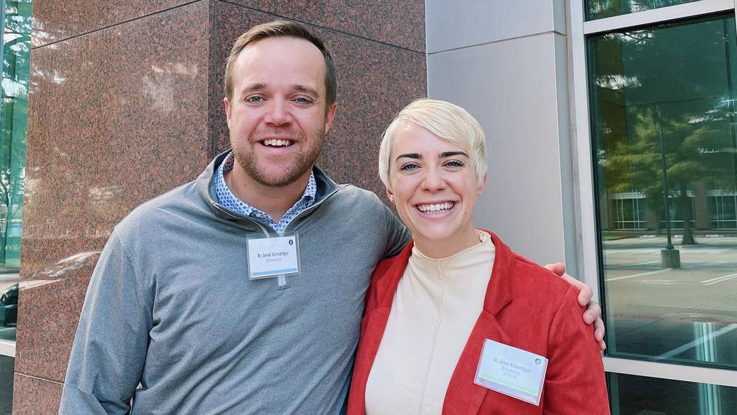 Dr. Jared and Dr. Anna Schoettger wearing name badges at an orthodontic conference
