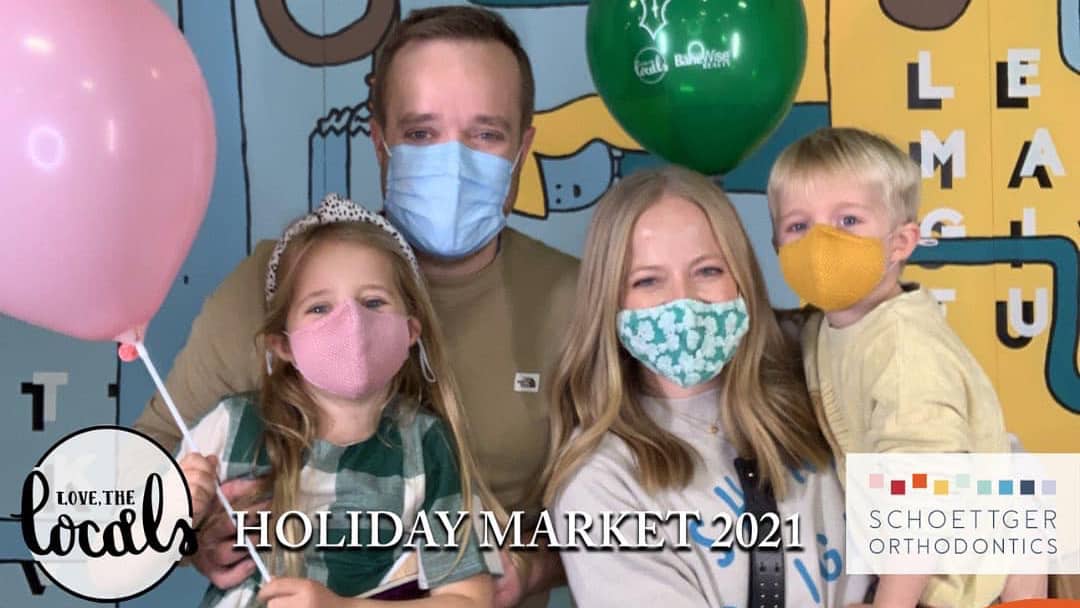 Masked family with balloons at the Love the Locals Holiday Market 2021 photo booth