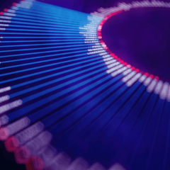 Abstract close-up of a curved, colorful data visualization chart with blue and red gradient lines and small white text labels on a dark background.