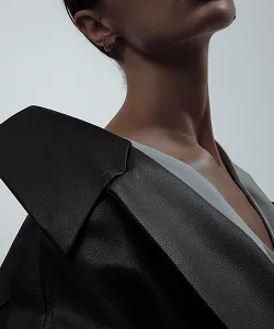 Close-up of a model wearing a structured black blazer