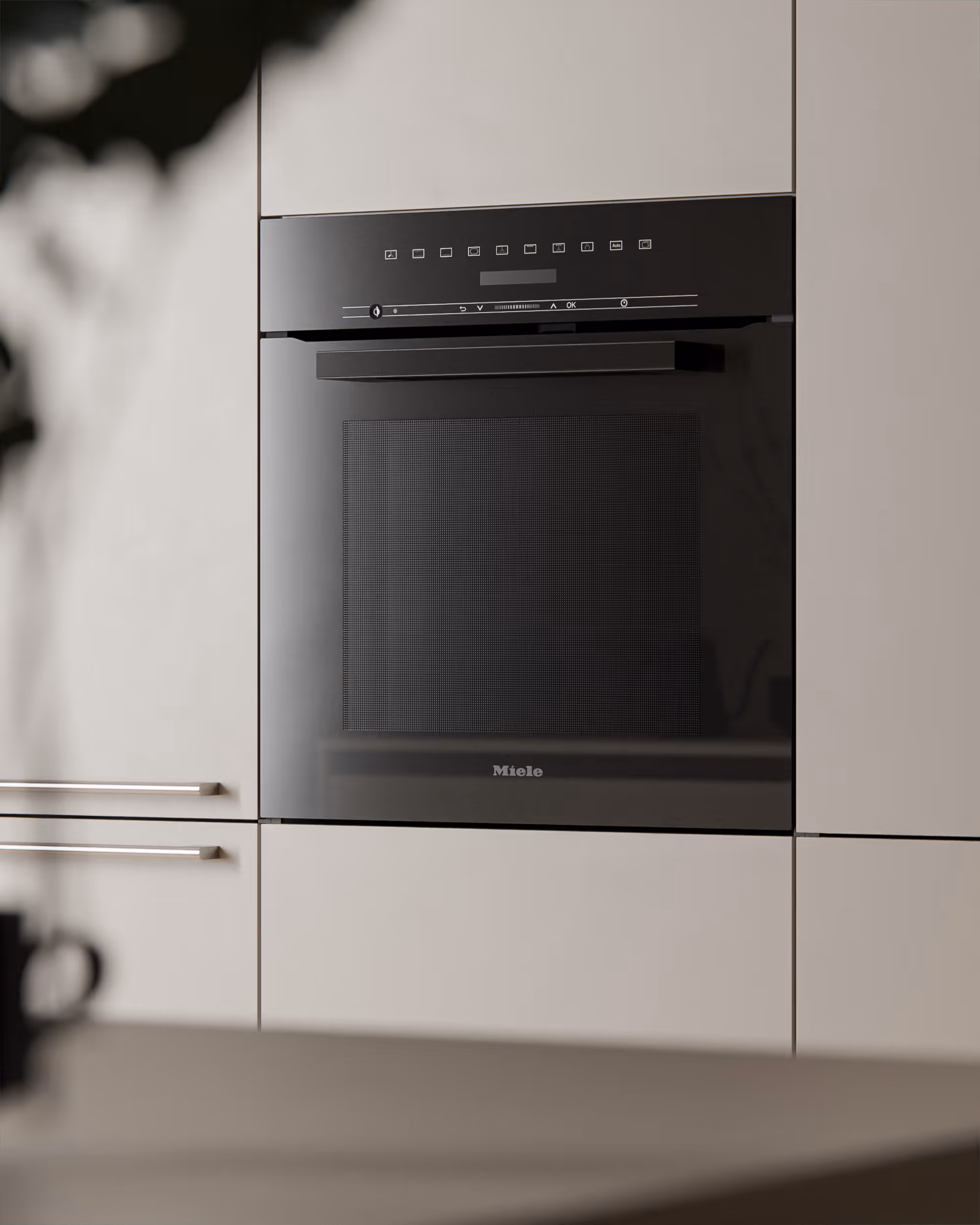 In einen Einbauschrank integrierter schwarzer Miele-Backofen mit digitalem Display.