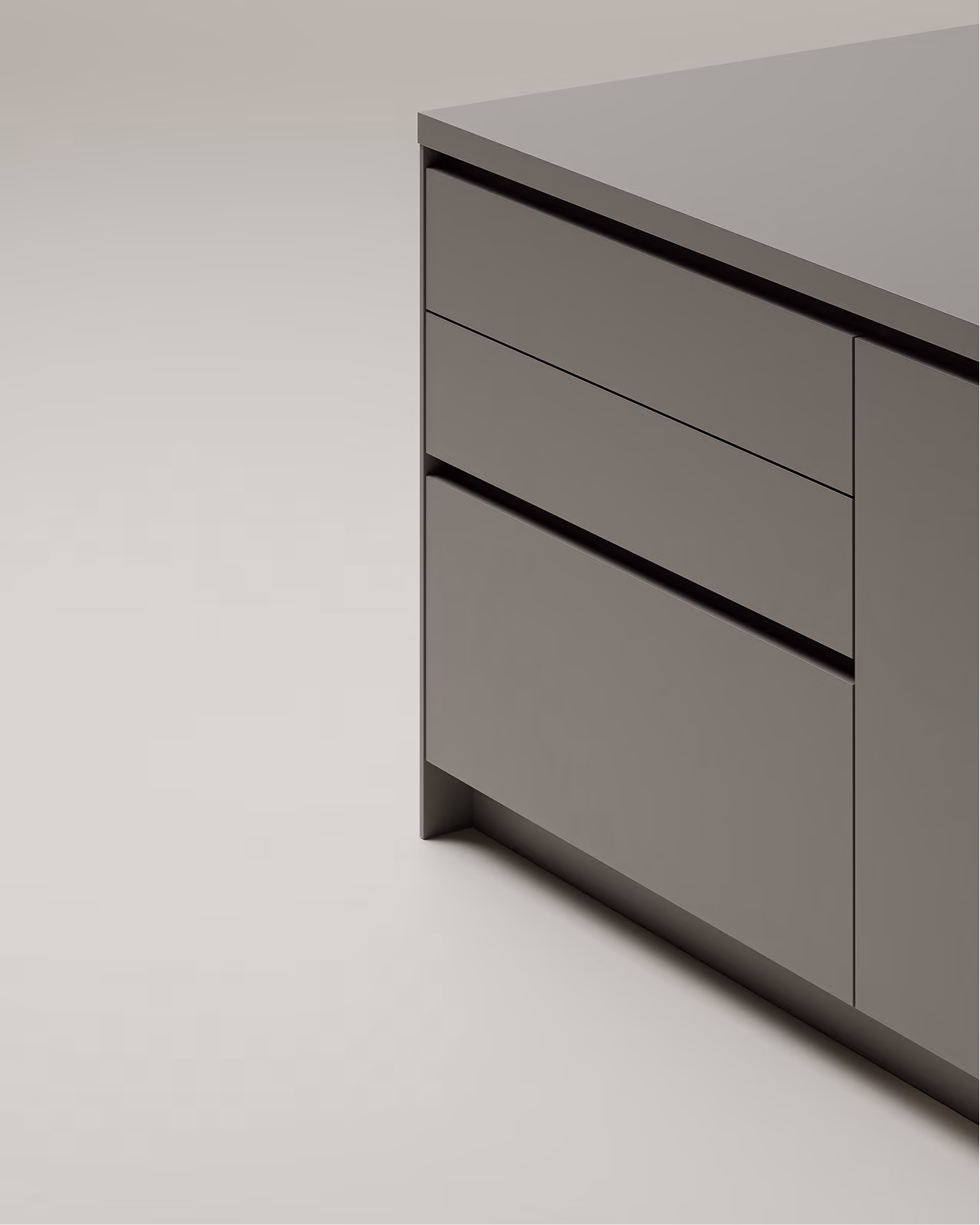 Ecke eines minimalistischen Küchenunterschranks mit matten grauen Schubladen und glatter Arbeitsplatte.