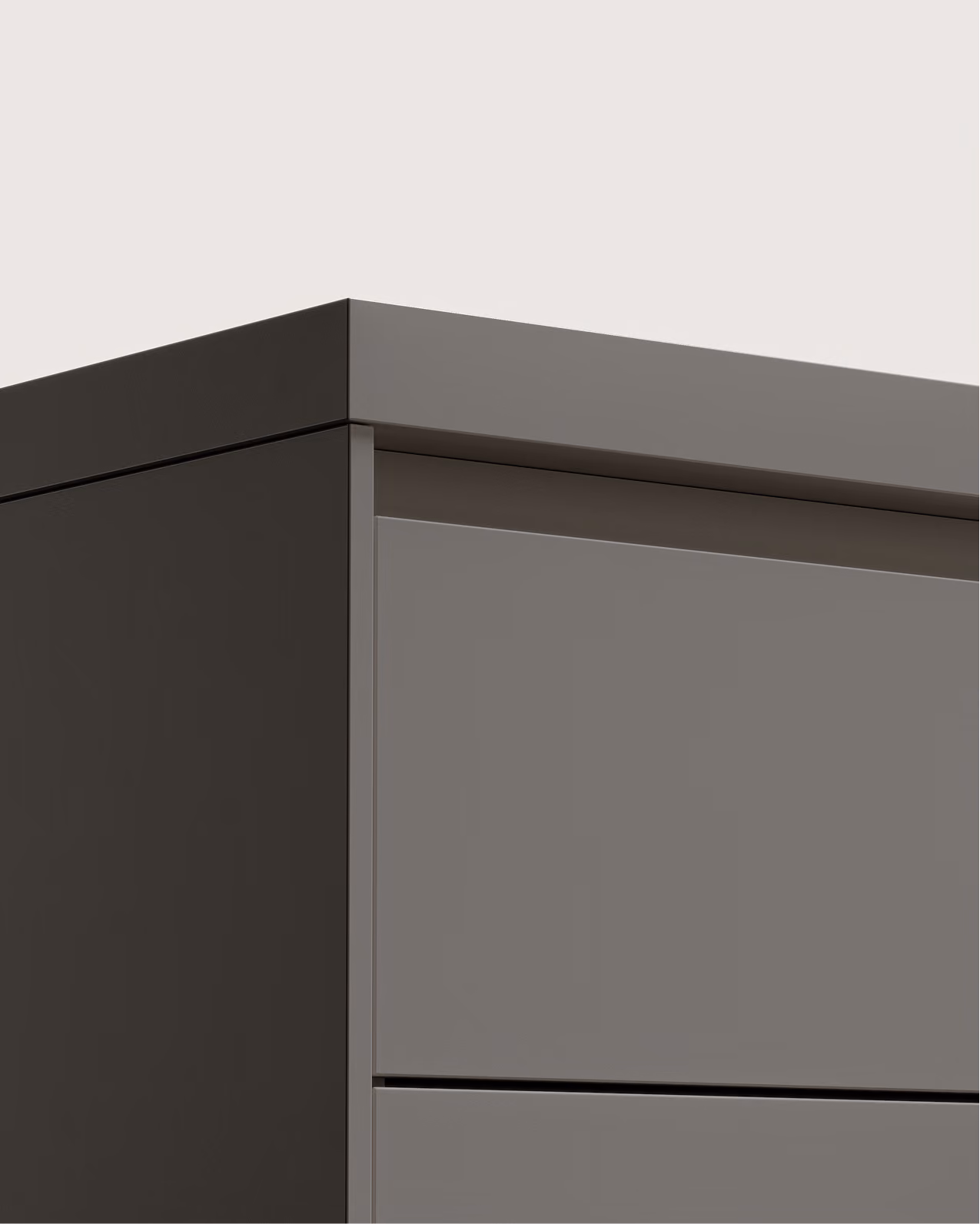 Nahaufnahme der oberen Ecke eines minimalistischen grauen Schranks mit klaren Kanten.