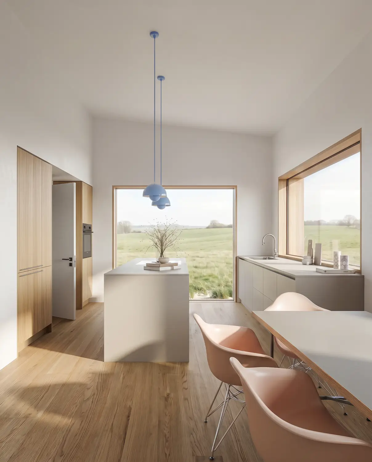 Moderne Küche mit grauen Schränken, rundem Marmor-Esstisch, Holzstuhl mit Geflecht und großer Vase mit Grünpflanzen.