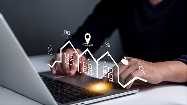 Person typing on a laptop with floating icons of houses, location pin, percentage, and piggy bank symbolizing real estate technology.