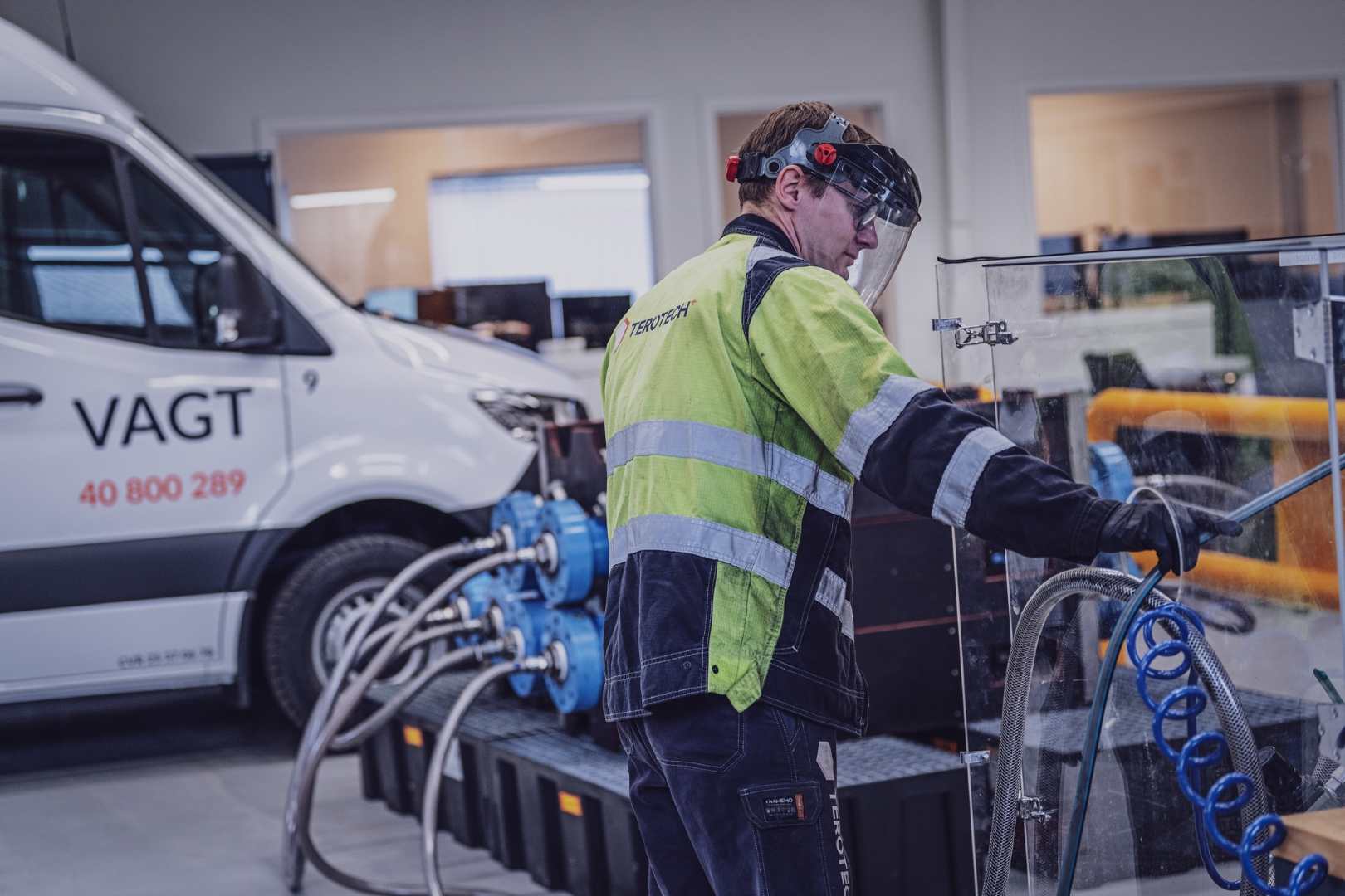Technician and car with hotline number.