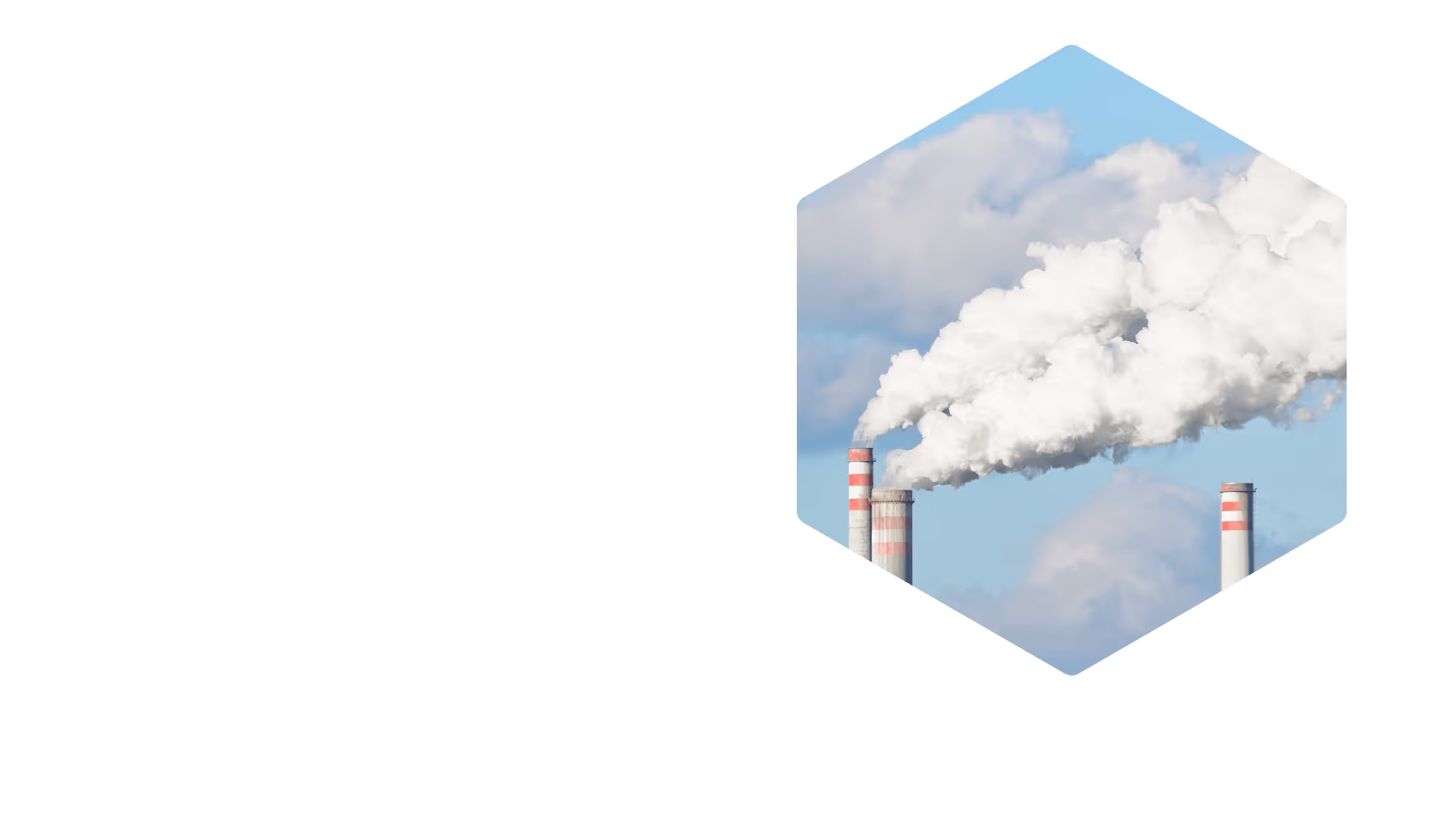 Industrial smokestacks emitting large white smoke clouds against a blue sky.