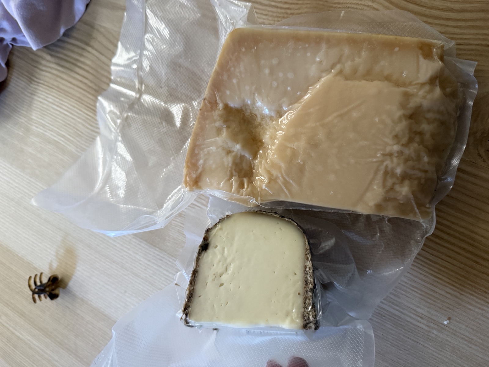 The Friday market haul: a wedge of parmigiano and a round of pecorino on our kitchen table