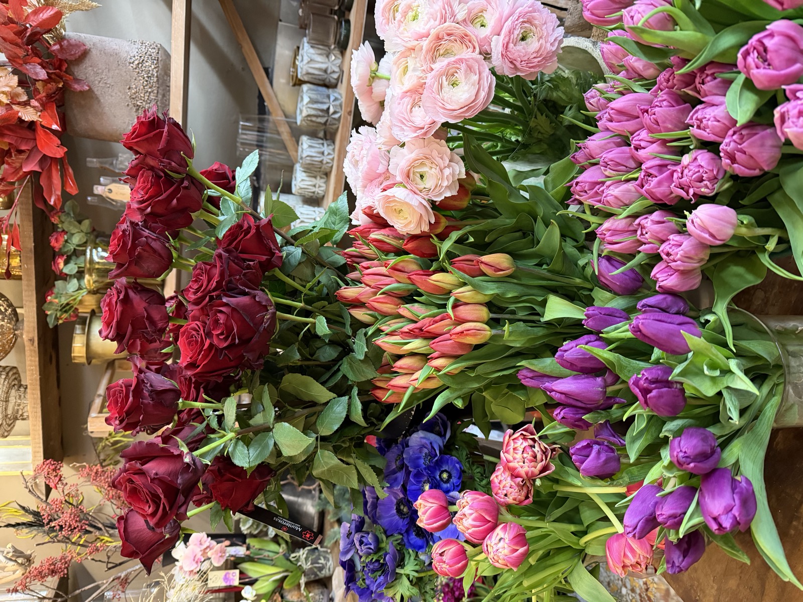Buckets of tulips, ranunculus, and roses at the flower shop, the Thursday errand that became a ritual