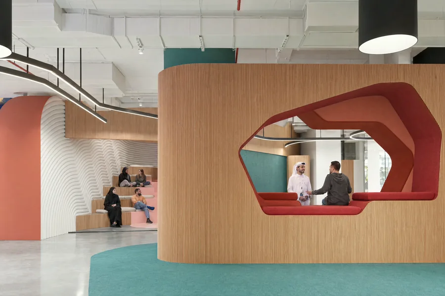 Render of the Innovation Hub: a timber-clad meeting pod with a red-framed opening.