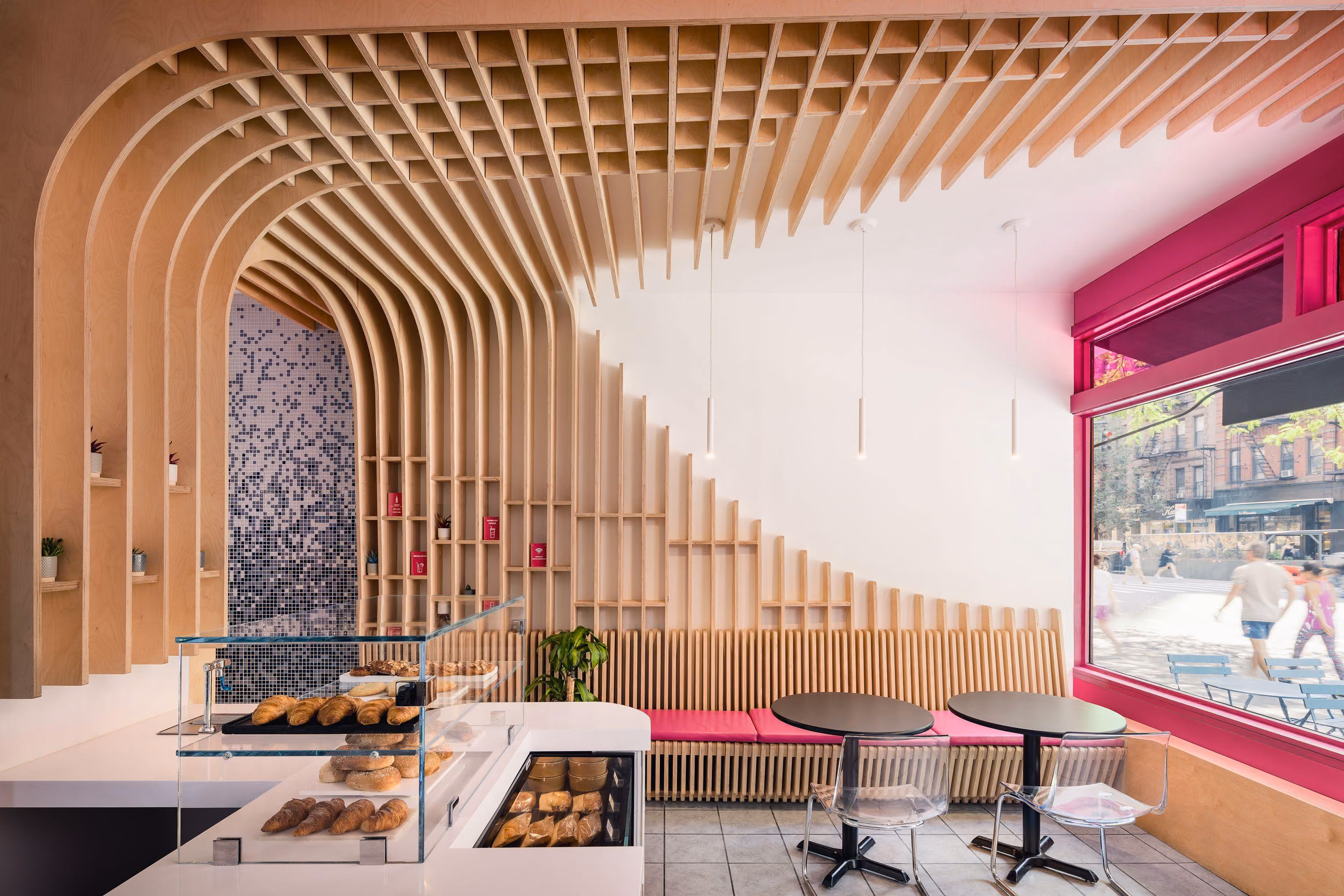 Birch arches and patterned mosaic surfaces at The Migrant Kitchen in New York.