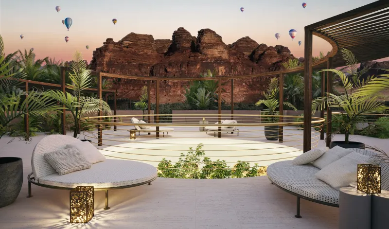 Cosmos House rooftop terrace at dusk with AlUla's sandstone cliffs behind