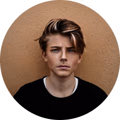 Portrait of a young man with short brown hair, wearing a black t-shirt against a brown background.