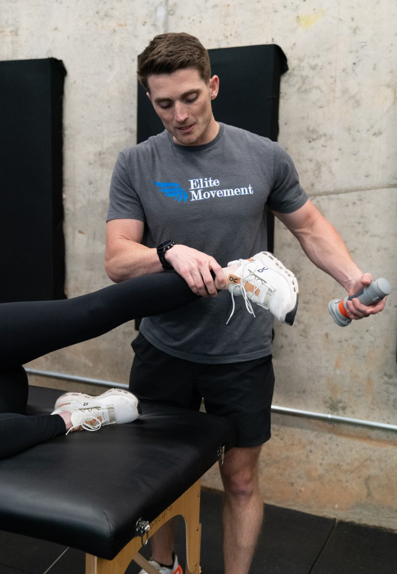  Athlete working with a performance coach during strength training at a sports performance training clinic in Winston-Salem, NC