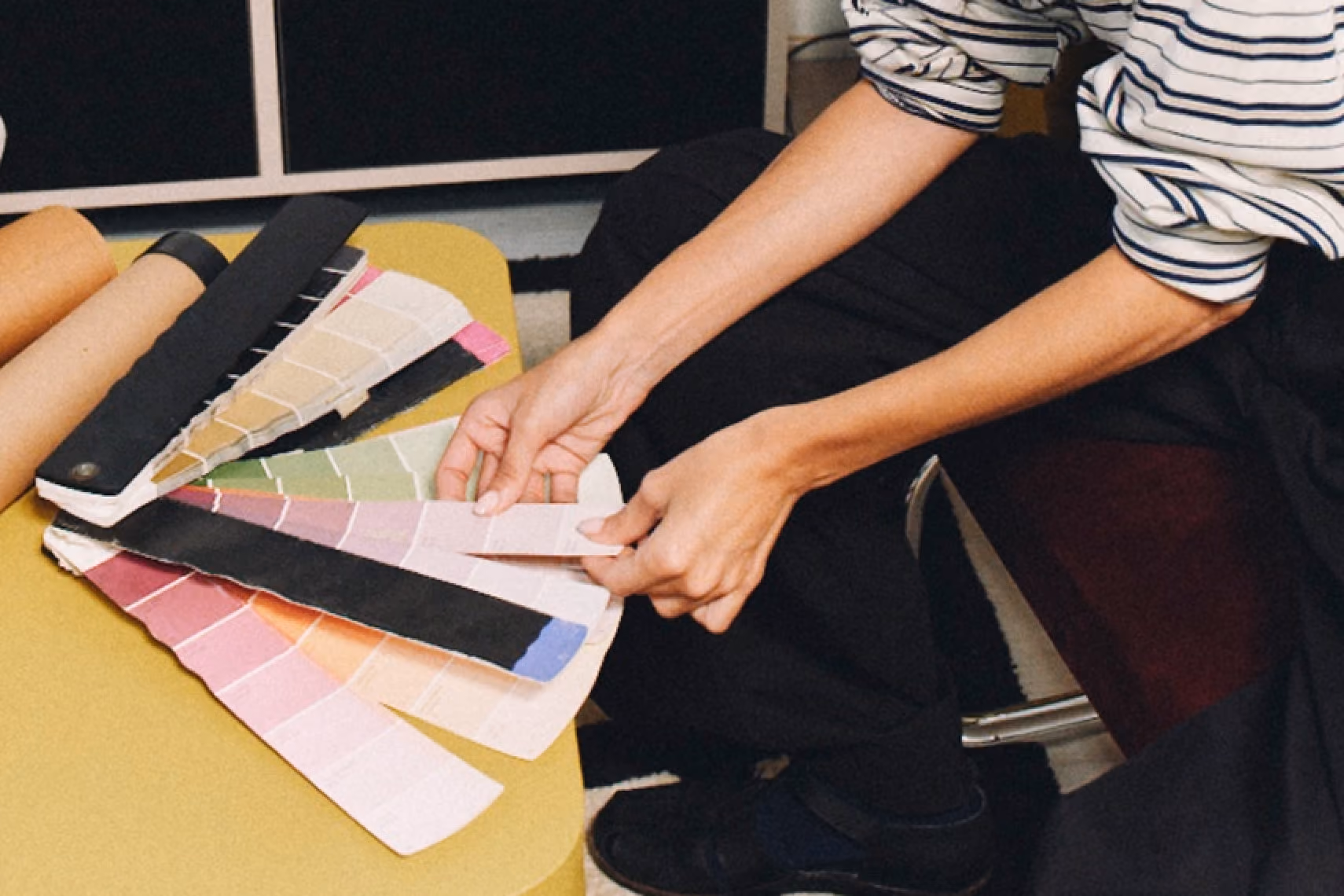 Person comparing colour swatches