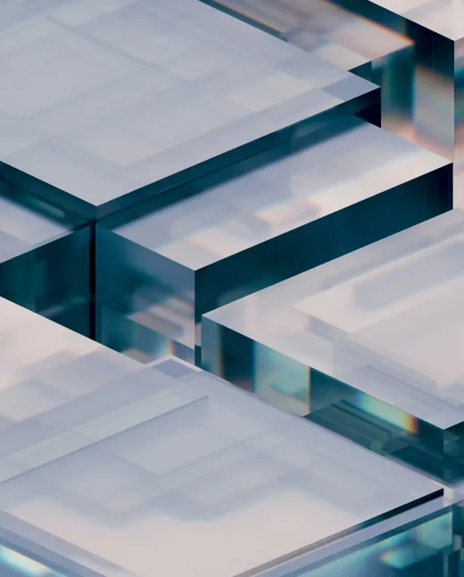 Close-up of transparent layered glass or crystalline cubes with reflections and blue tint.