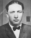 Black and white portrait of a man wearing a suit and bow tie with a serious expression.