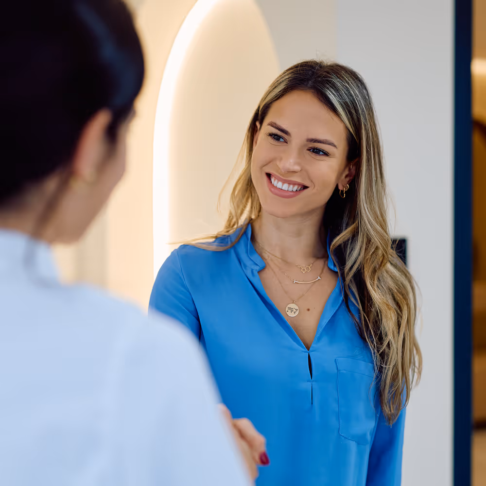 friendly dentist talking to patient bright clinic