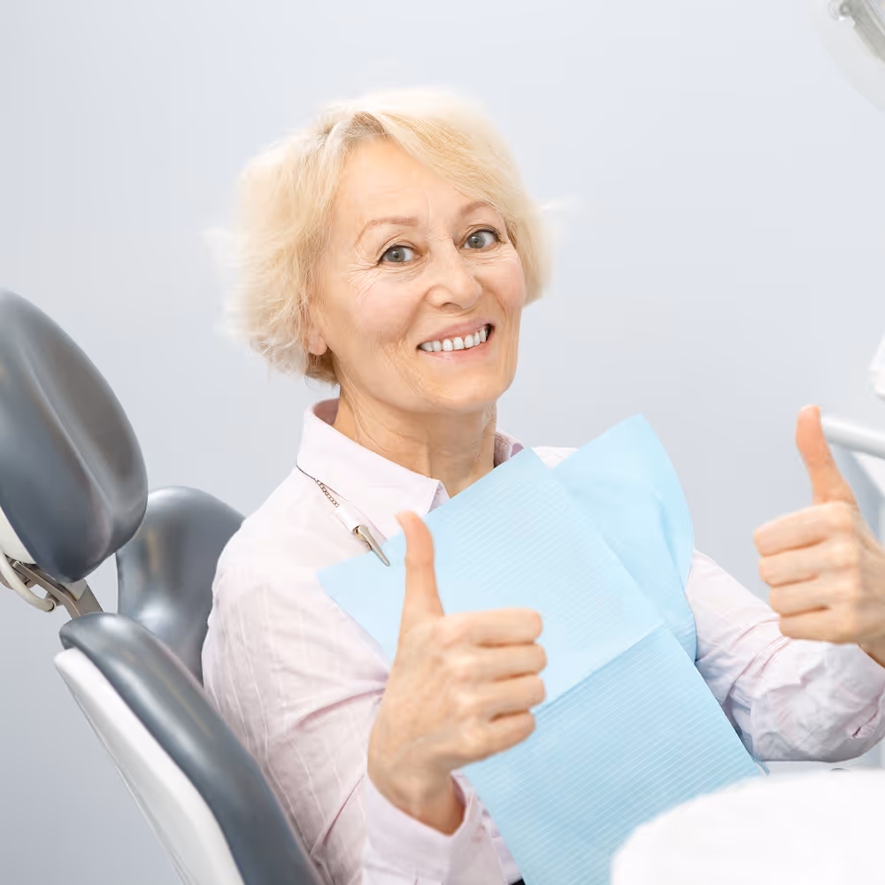 Smiling patient reviewing affordable dental plan savings at Organ Mountain Dental