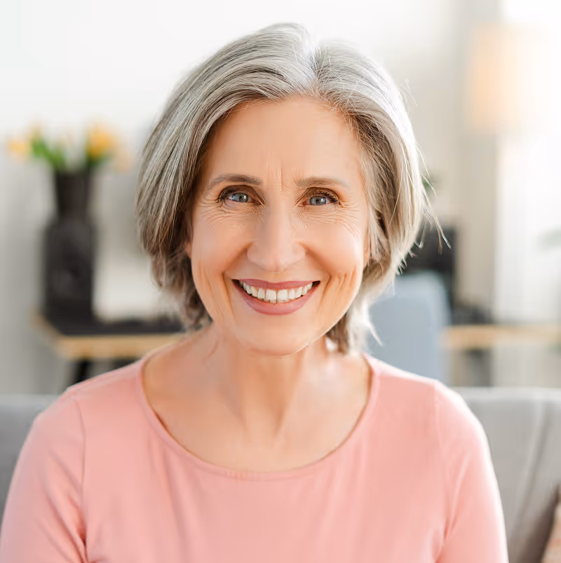 Senior patient smiling confidently after 3-on-6 dental implant restoration at Organ Mountain Dental