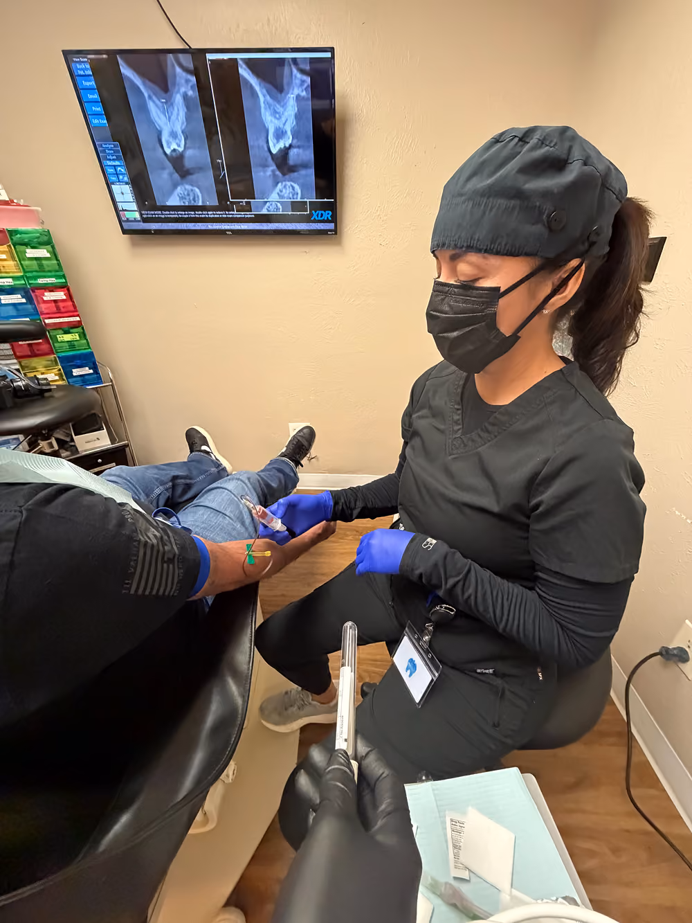 Liz, a certified phlebotomy technician at Organ Mountain Dental, drawing blood to prepare PRF for a patient's dental bone graft in Las Cruces
