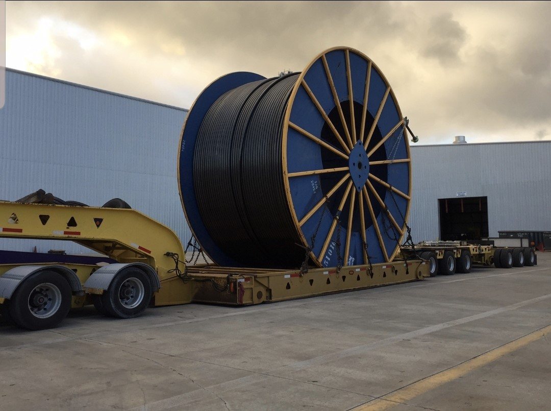 Oversized cable reel on a lowboy trailer, heavy haul project cargo