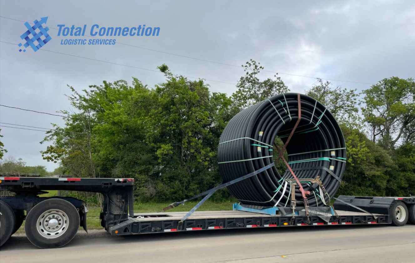 Reel on a flatbed with pipestake supports and cross strapping