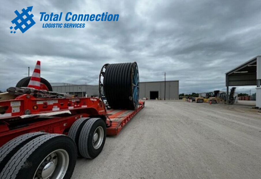 Reel chained to a double drop trailer before departure