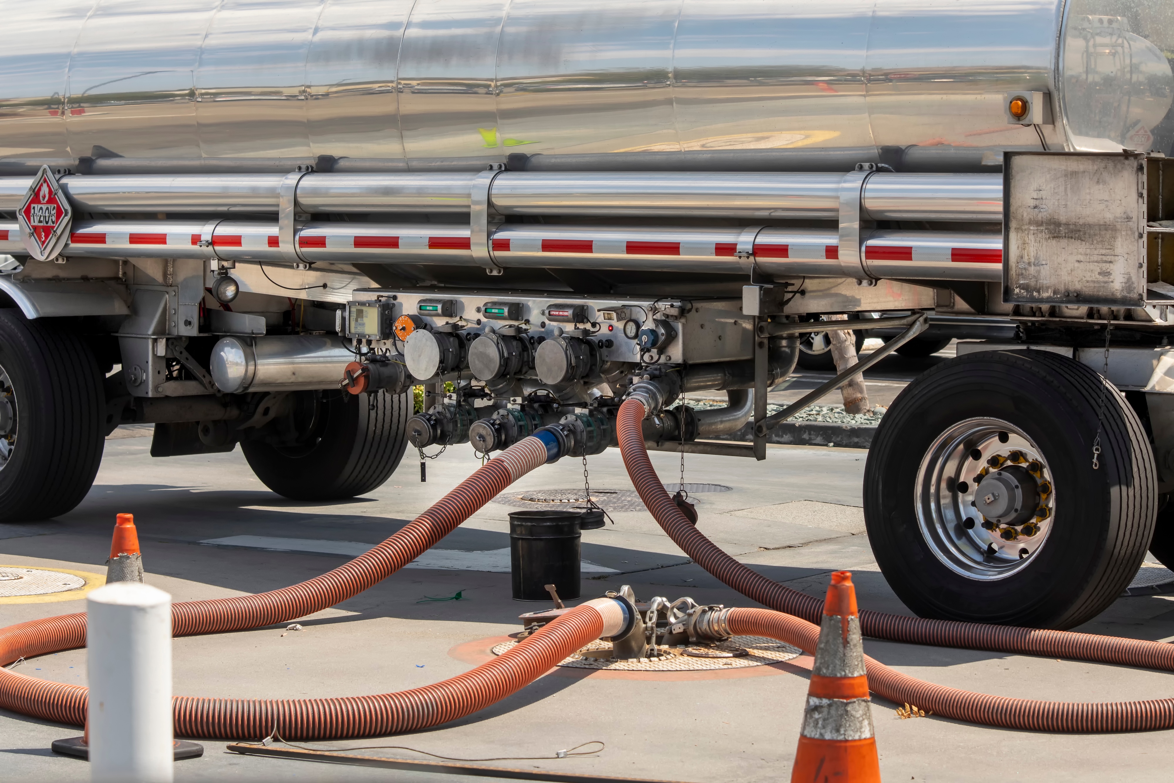 Tanker unloading through transfer hoses at a receiver