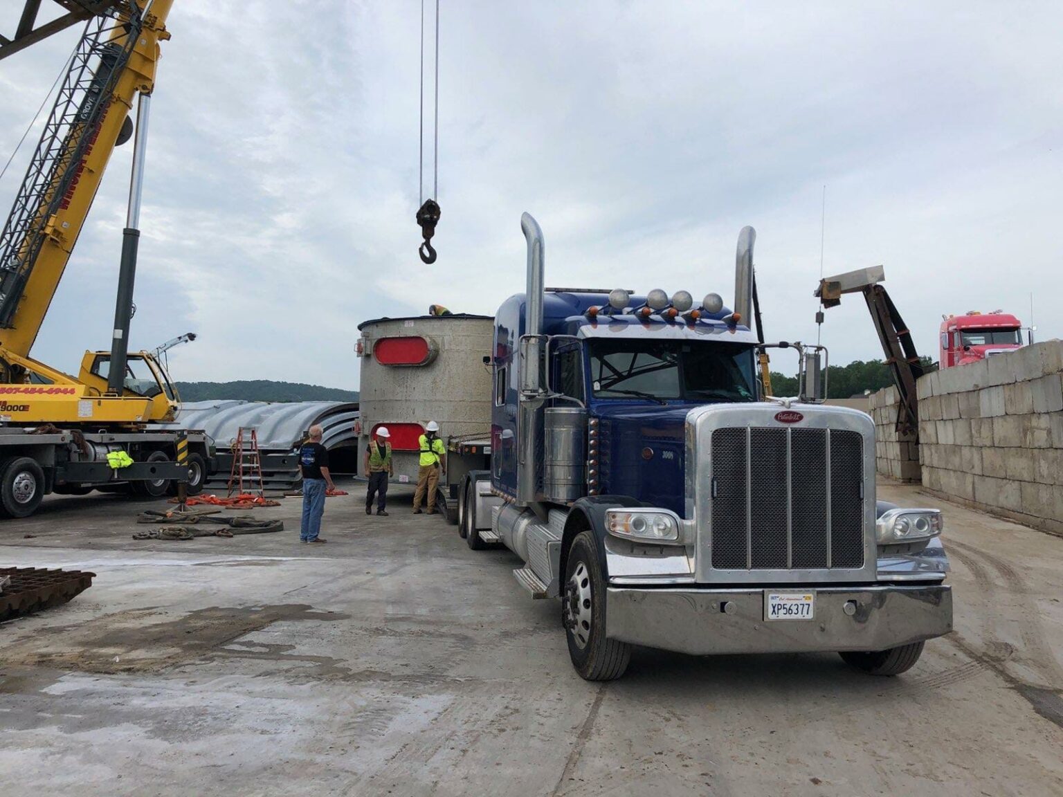 White plant module on a lowboy trailer leaving the terminal