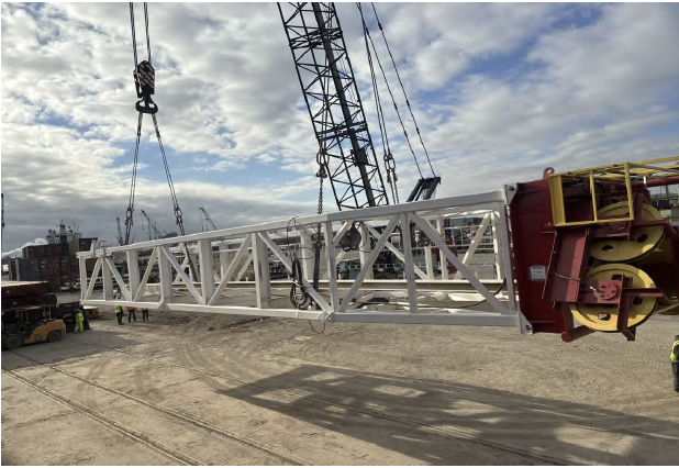 Rig PR-14 mast section lifted by crane at WATCO Terminal Houston