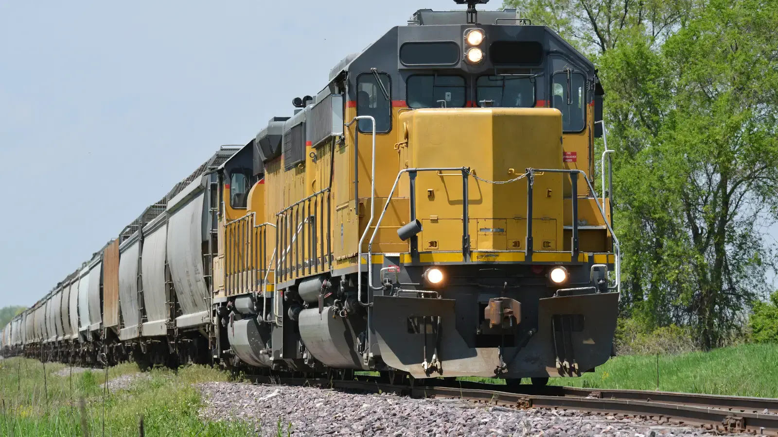 Freight train hauling tank and bulk cargo cars, the rail leg a liquid bulk broker coordinates alongside tanker capacity