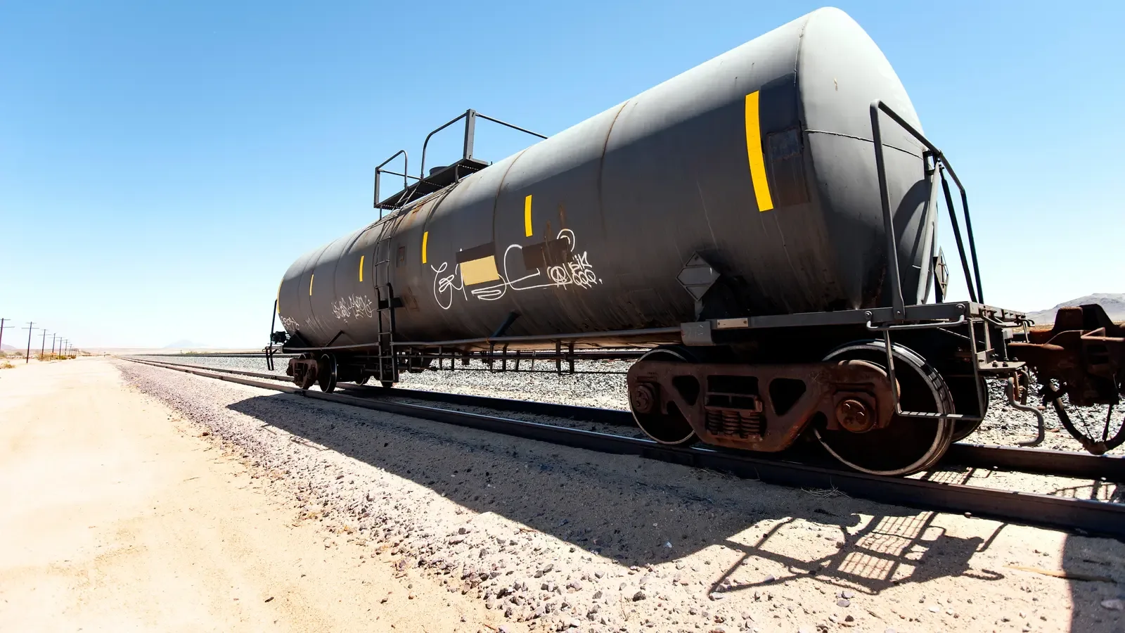 Tank car on desert rail line reflects the equipment plant teams must budget for before shipment history exists