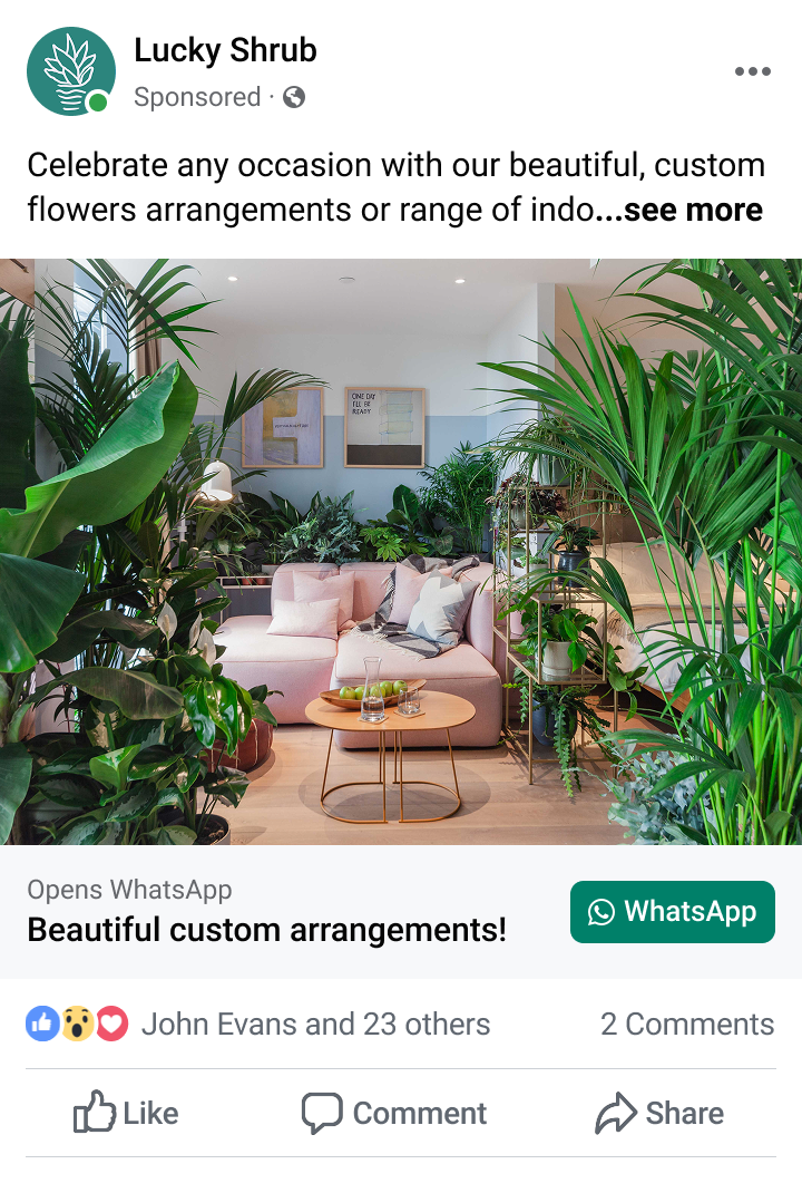 Modern living room with a pink sofa, wooden coffee tables, and numerous lush green indoor plants around.