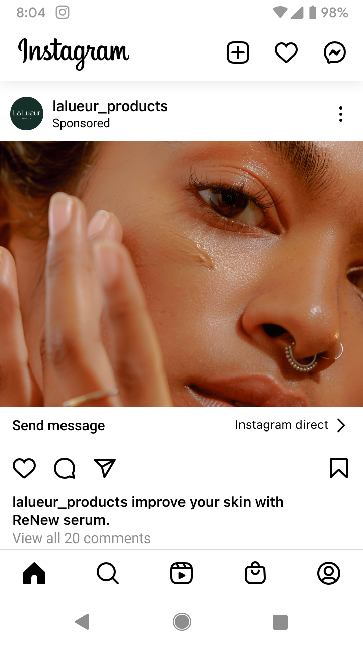Close-up of a person applying clear serum to their cheek, highlighting smooth skin and a septum piercing.