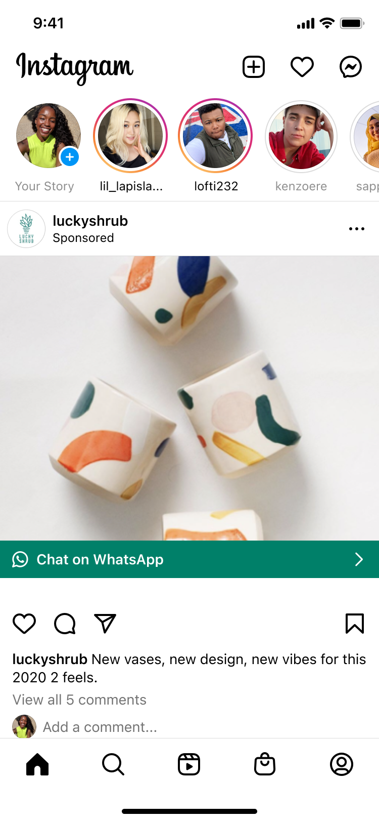 Four small white ceramic vases with colorful abstract shapes in orange, blue, green, and yellow, displayed on a white surface.