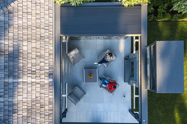 Aerial view of a louvered pergola roof over a patio