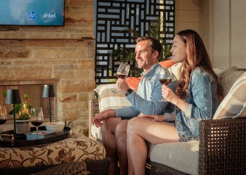 Couple relaxing with wine on a screened porch