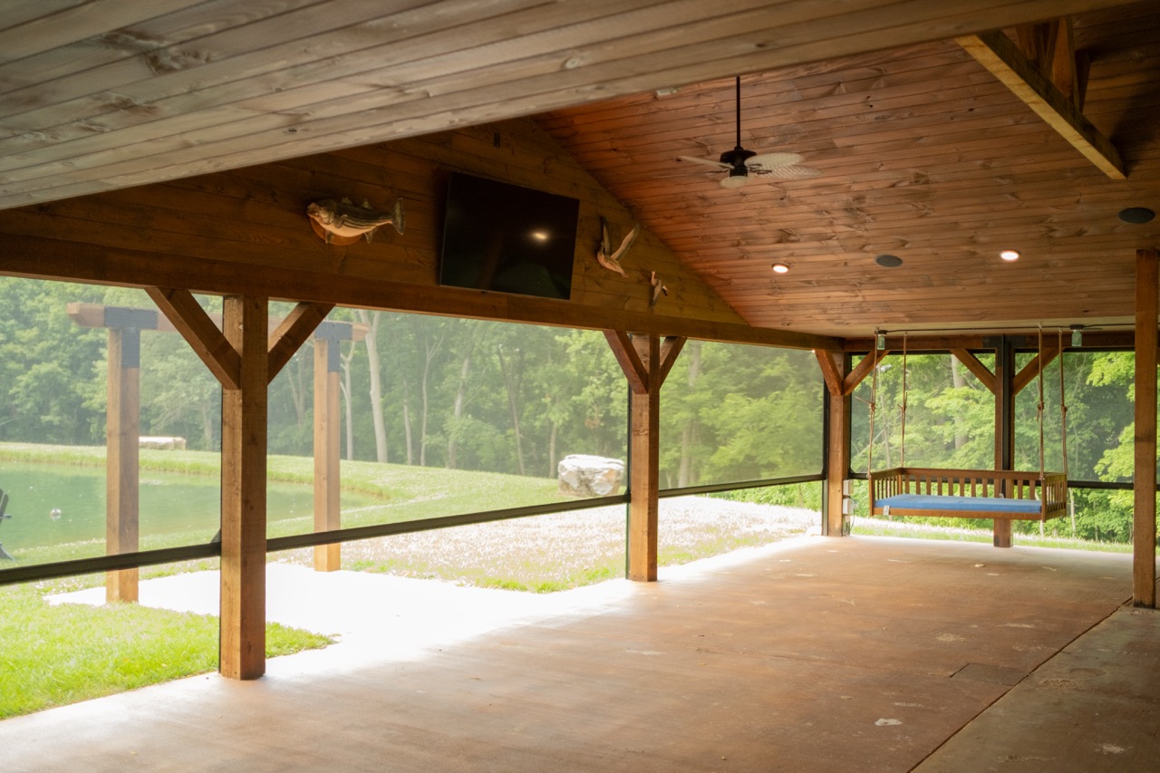 Retractable screen door at a home's entryway with patio seating