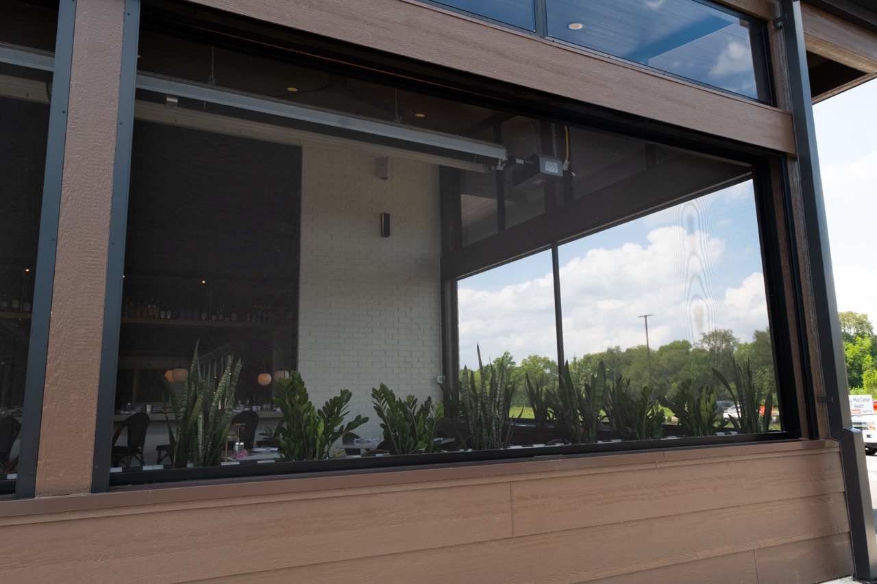 Close-up of a retractable screen and motor housing on Salento Italia's patio enclosure