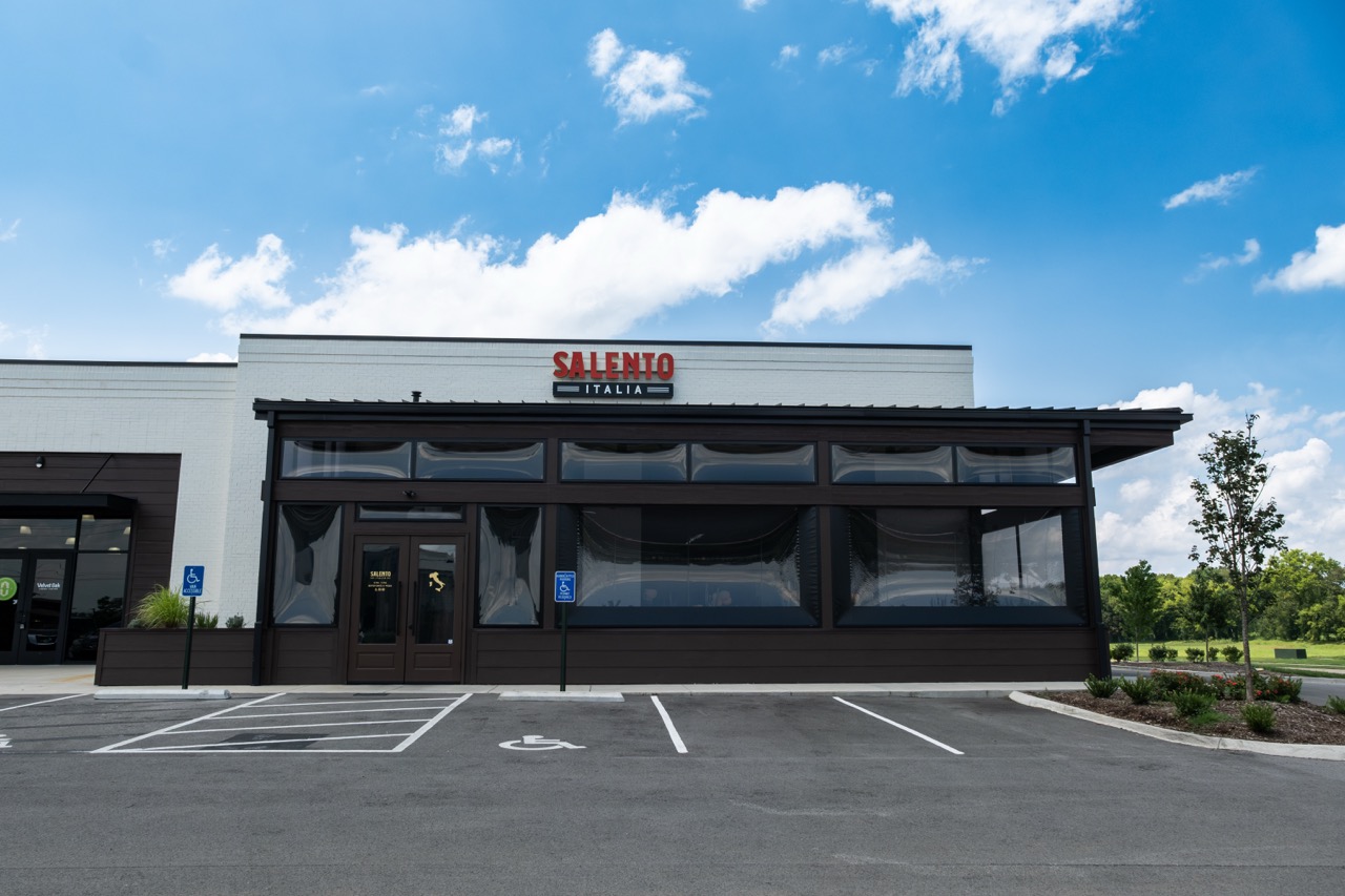 Exterior of Salento Italia with motorized screens closed across the patio enclosure