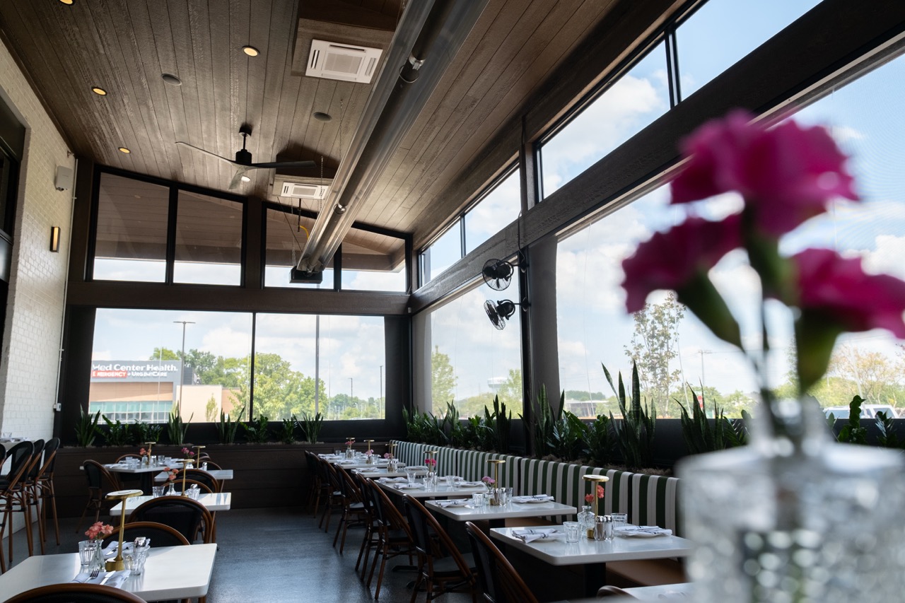 Interior dining room at Salento Italia set for service, with retractable screens along the windows