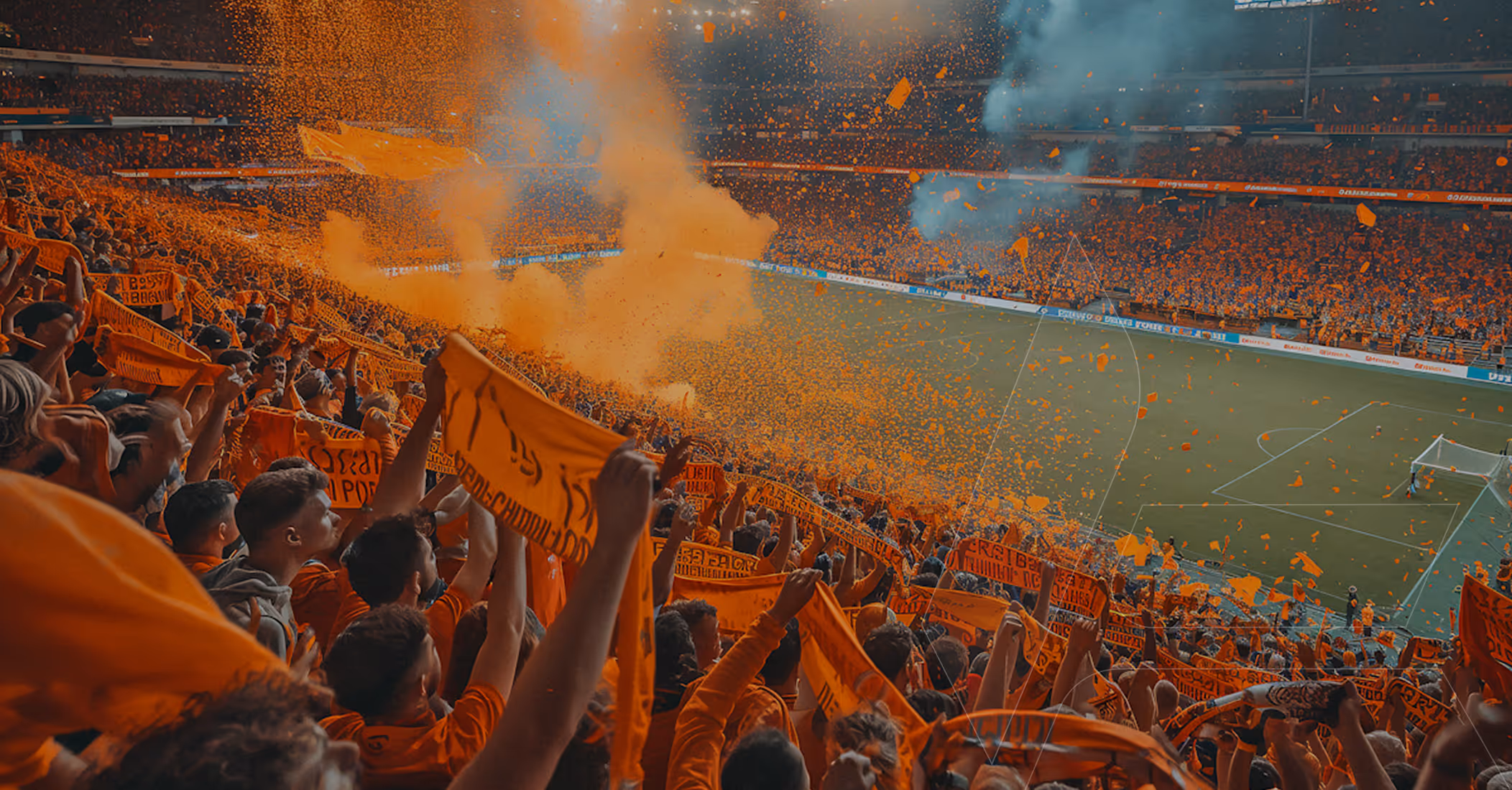 A packed football stadium from a high angle, with a crowd of passionate fans holding orange scarves, and orange and blue smoke rising from the stands during a match.