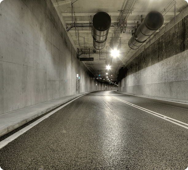 Empty road inside a lit tunnel
