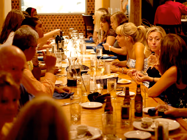 people dining at a long table